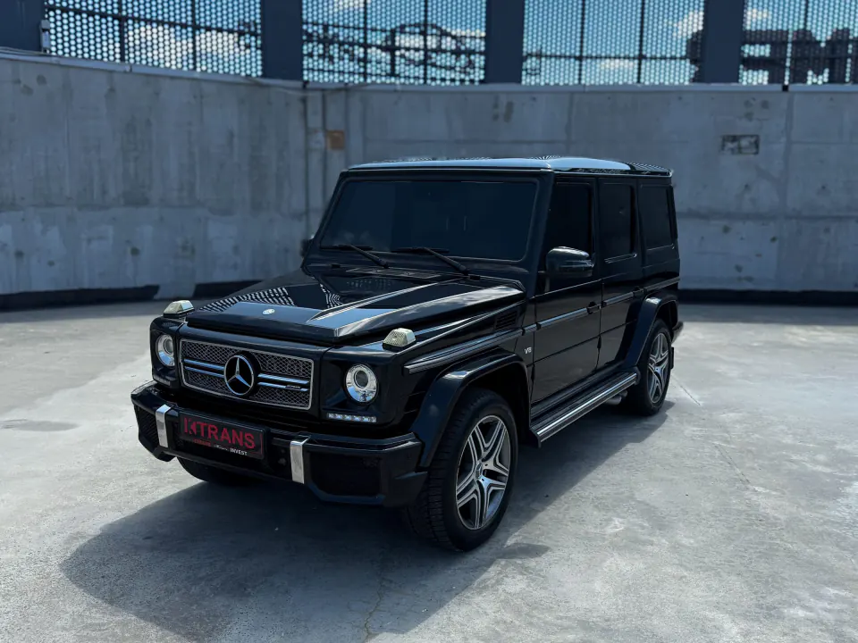 Black 2013 Mercedes-Benz G500 with a KTRANS plate on a concrete parking garage roof