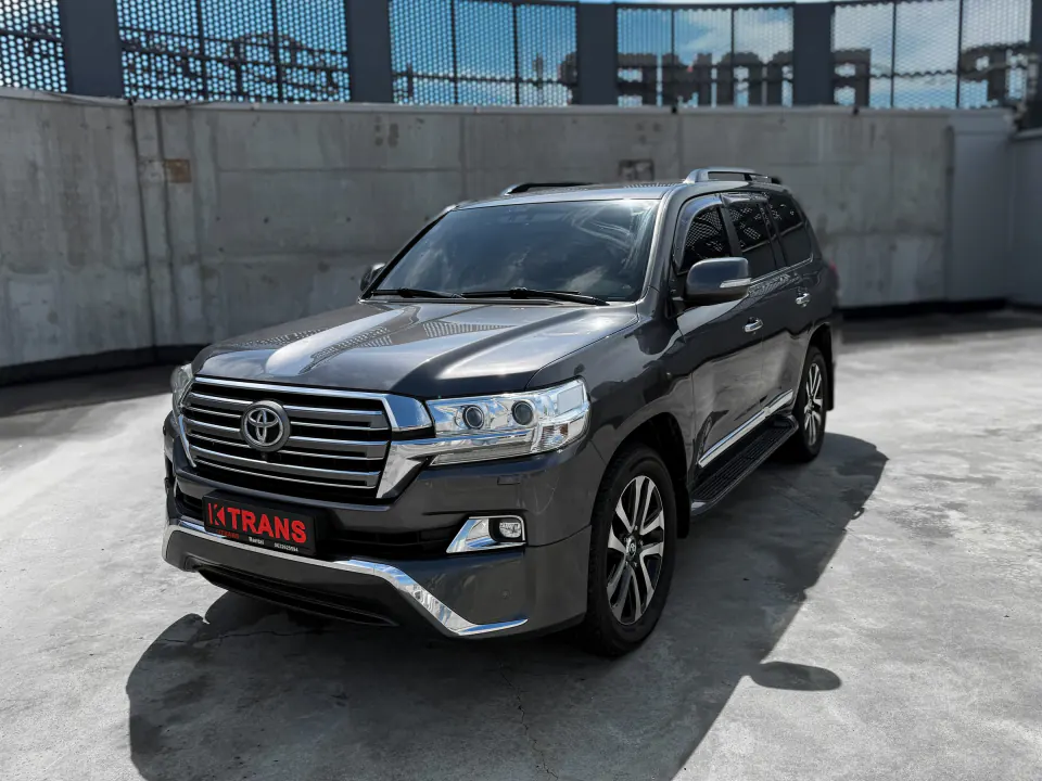 Dark gray 2017 Toyota Land Cruiser 200 with a KTRANS plate on a concrete parking garage roof