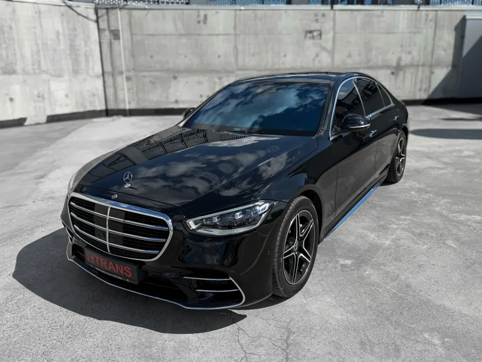 Black 2021 Mercedes-Benz S350d with a KTRANS plate on a concrete parking garage roof
